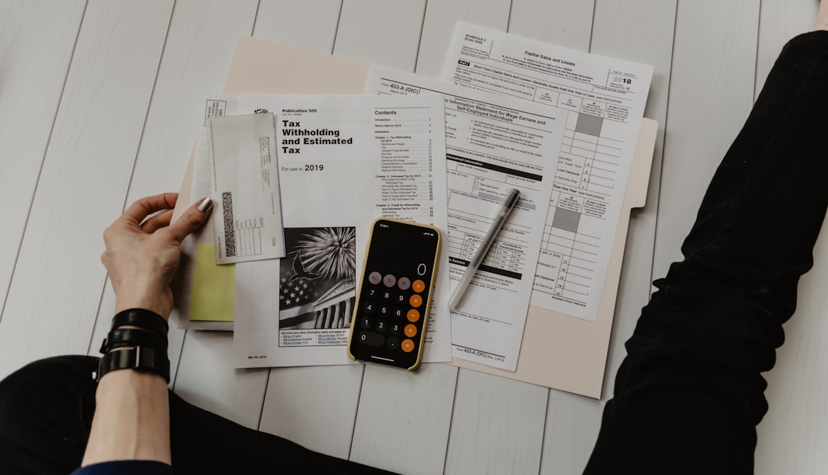 Financial documents and a calculator, representing debt recovery
