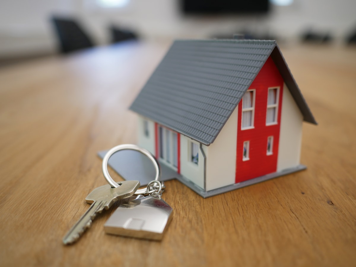 A model house with keys, representing a property transaction